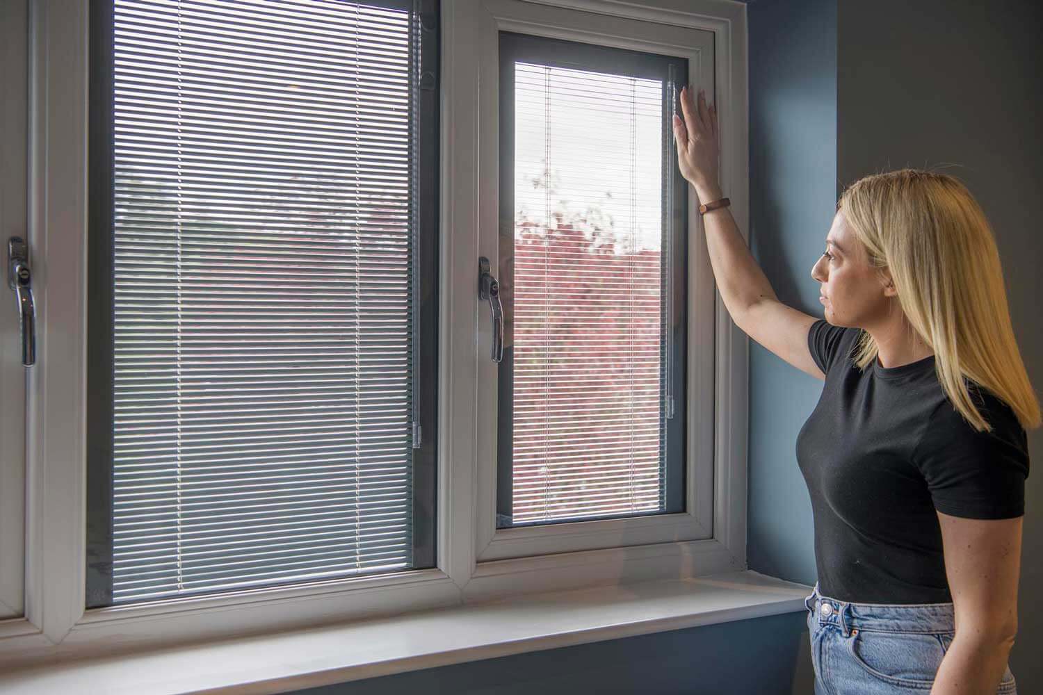 Blinds in Glass in Hatfield: adjusting white venetian integral blinds in a window