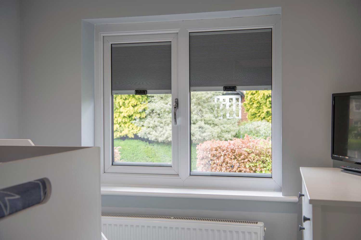 Blinds in Glass in Hatfield: grey integral blinds in a bedroom window