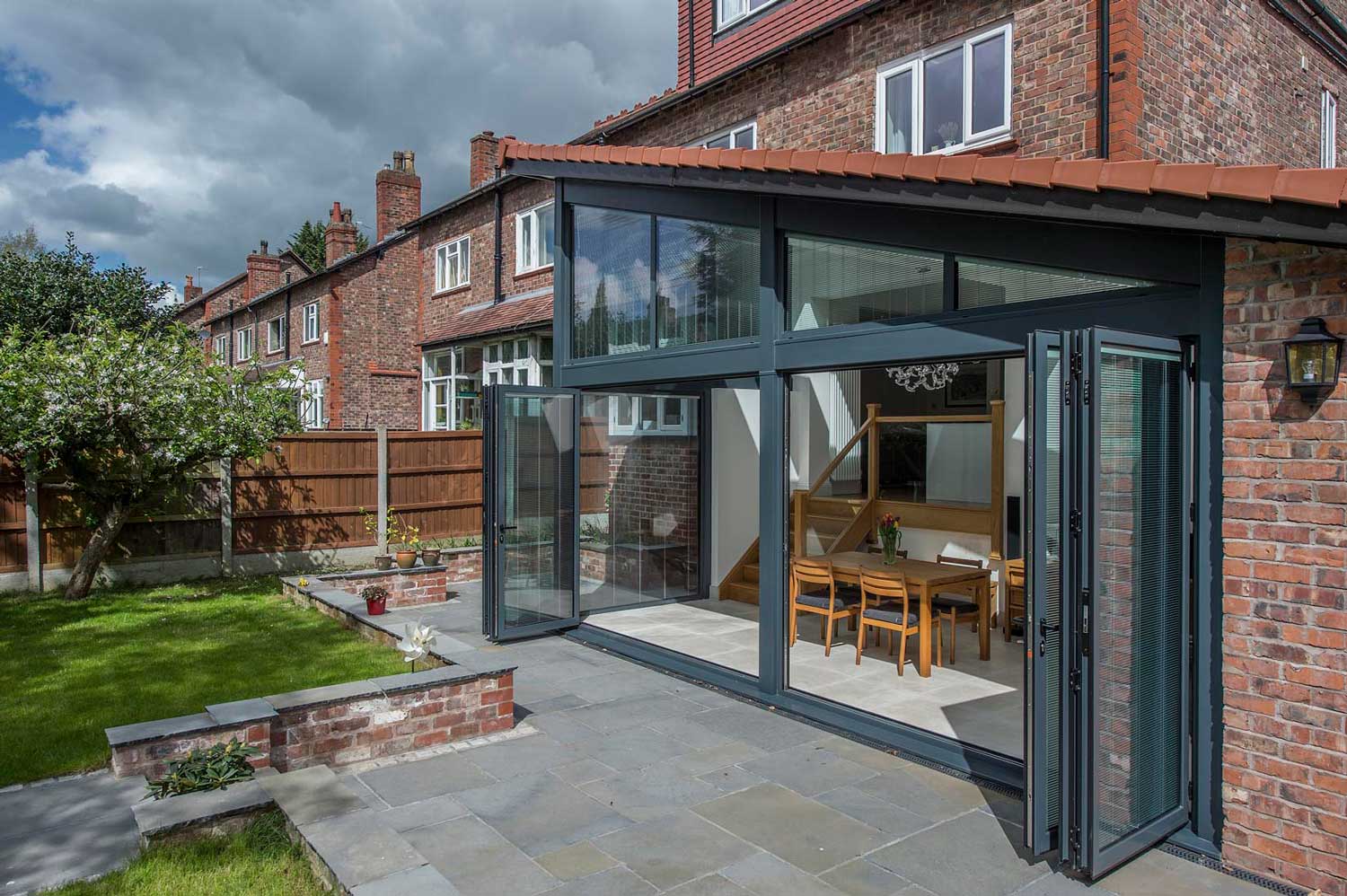 Blinds in Glass in Hatfield: integral blinds in bifold doors on a brick extension opening onto a patio