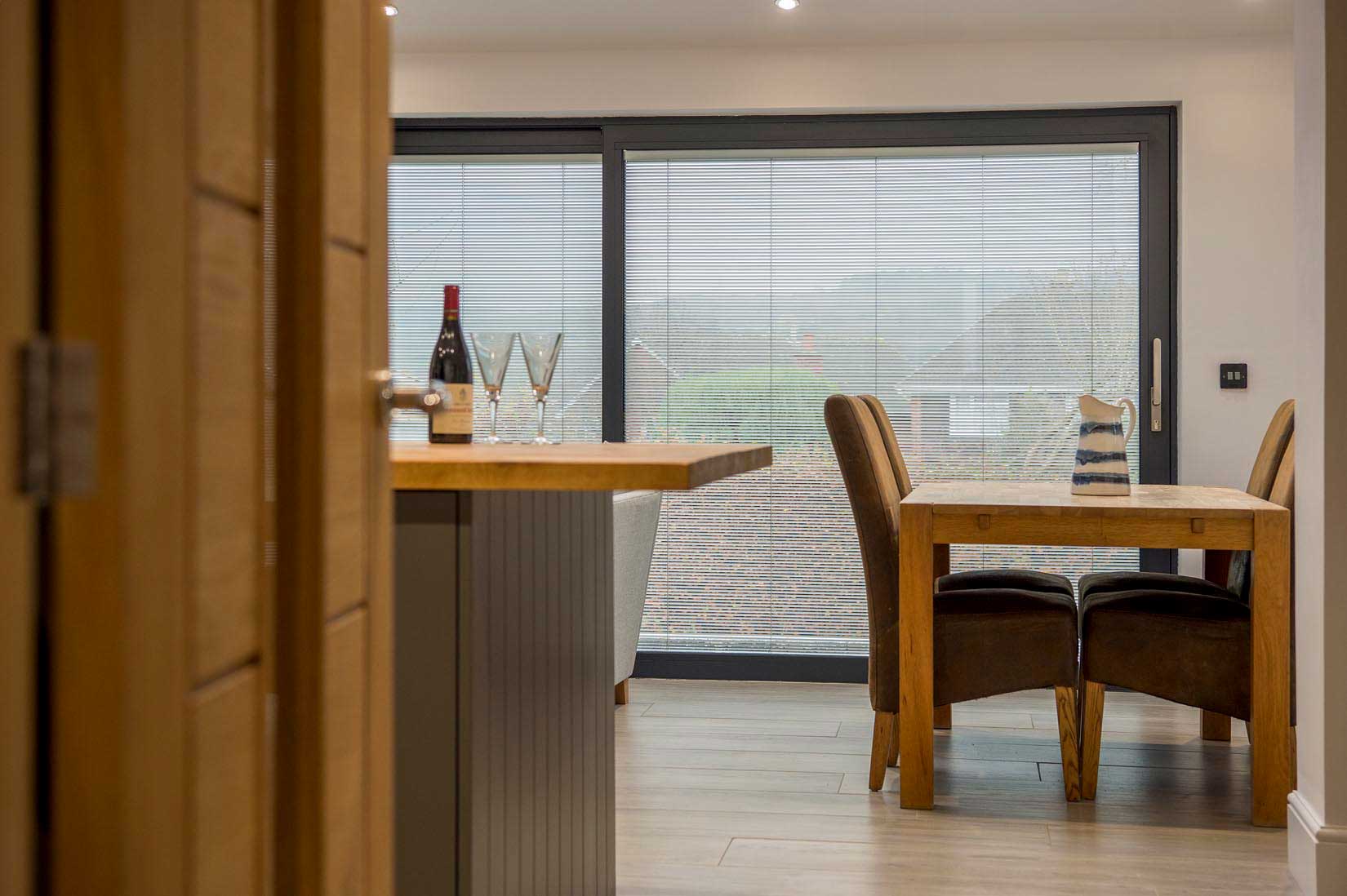Blinds in Glass in Hatfield: integral blinds in dining-room patio doors viewed through an oak door