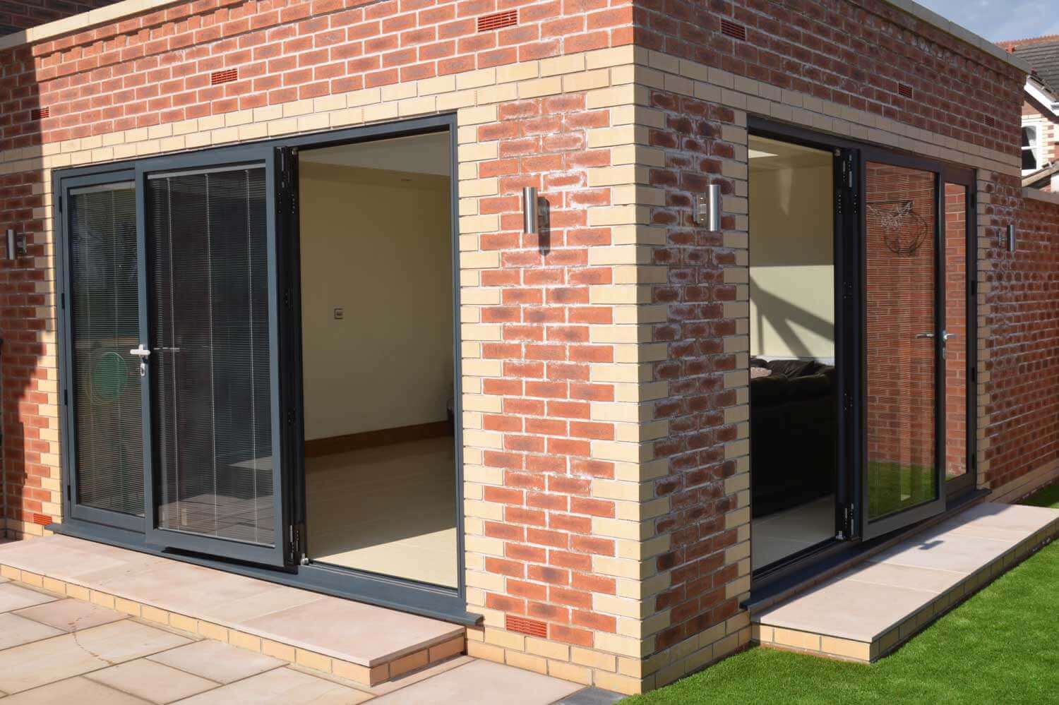 Blinds in Glass in Hatfield: integral blinds in the corner bifold doors of a brick garden room