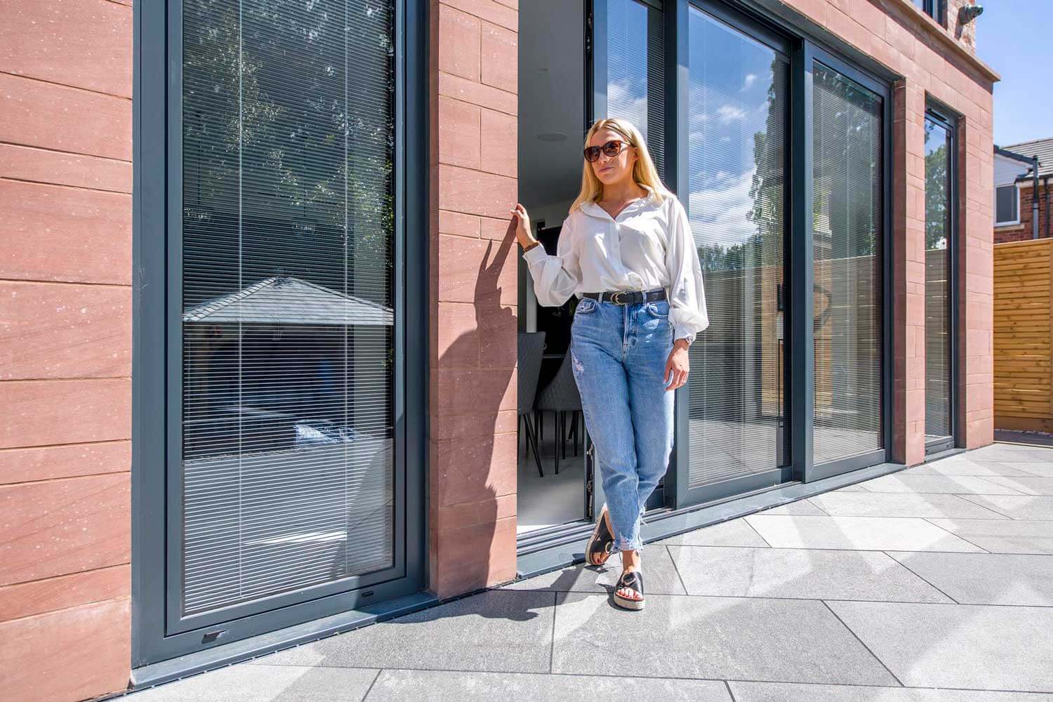 Blinds in Glass in Hatfield: integral blinds in the sliding doors of a sandstone-clad house