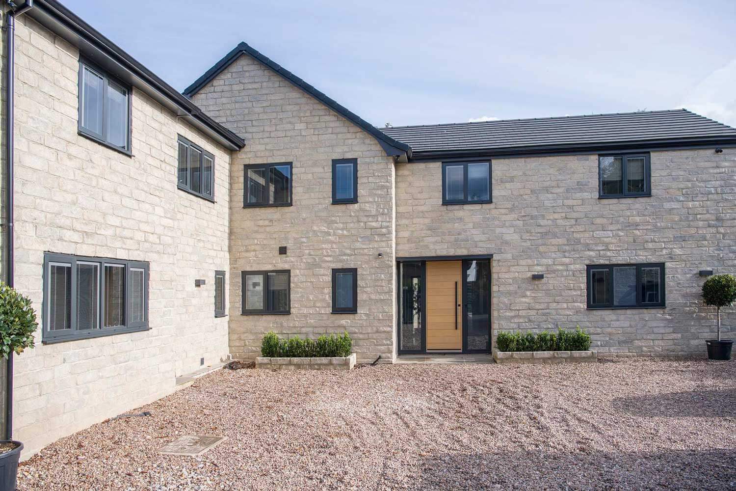 Blinds in Glass in Hatfield: integral blinds in the windows of a stone house with an oak front door